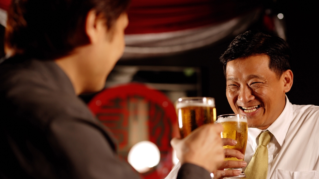 Two chinese men drinking beer together